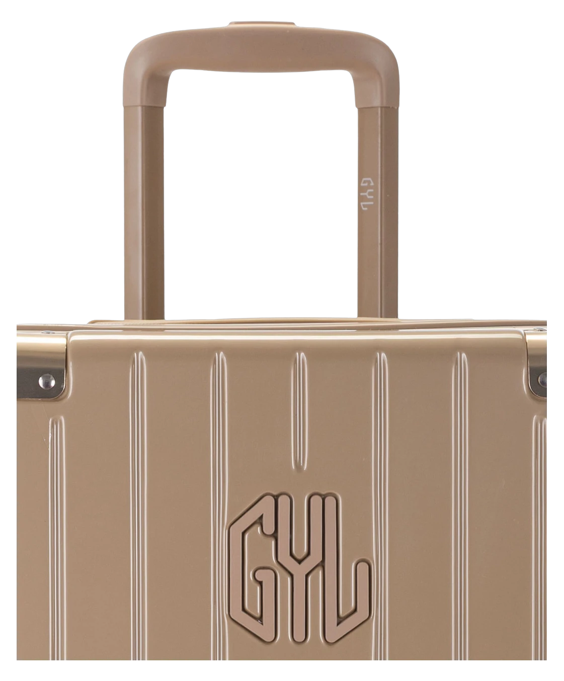 Valise Trunk L Intemporelle GYL en polycarbonate 71 cm coloris champagne gros plan sur la poignee trolley et les coins renforces