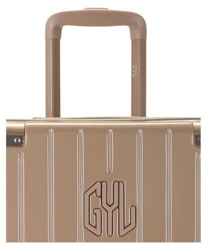 Valise Trunk L Intemporelle GYL en polycarbonate 71 cm coloris champagne gros plan sur la poignee trolley et les coins renforces