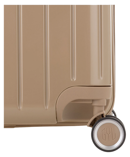 Valise Trunk L Intemporelle GYL en polycarbonate 71 cm coloris champagne gros plan sur une roulette double 360 degres siglee GYL