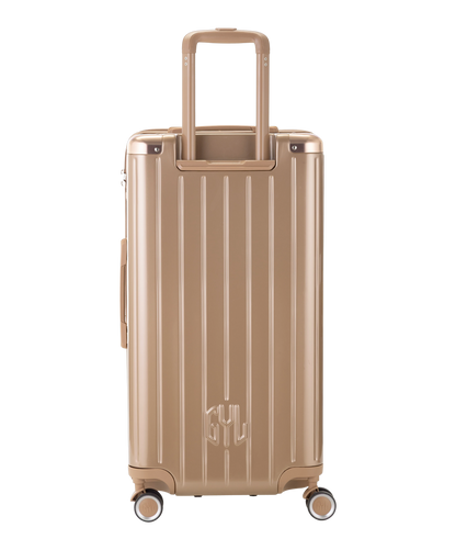 Valise Trunk L Intemporelle GYL en polycarbonate 71 cm coloris champagne vue de dos avec trolley telescopique deploye