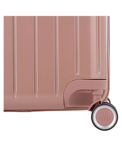 Valise Trunk L Intemporelle GYL en polycarbonate 71 cm coloris rose gold gros plan sur une roulette double 360 degres siglee GYL