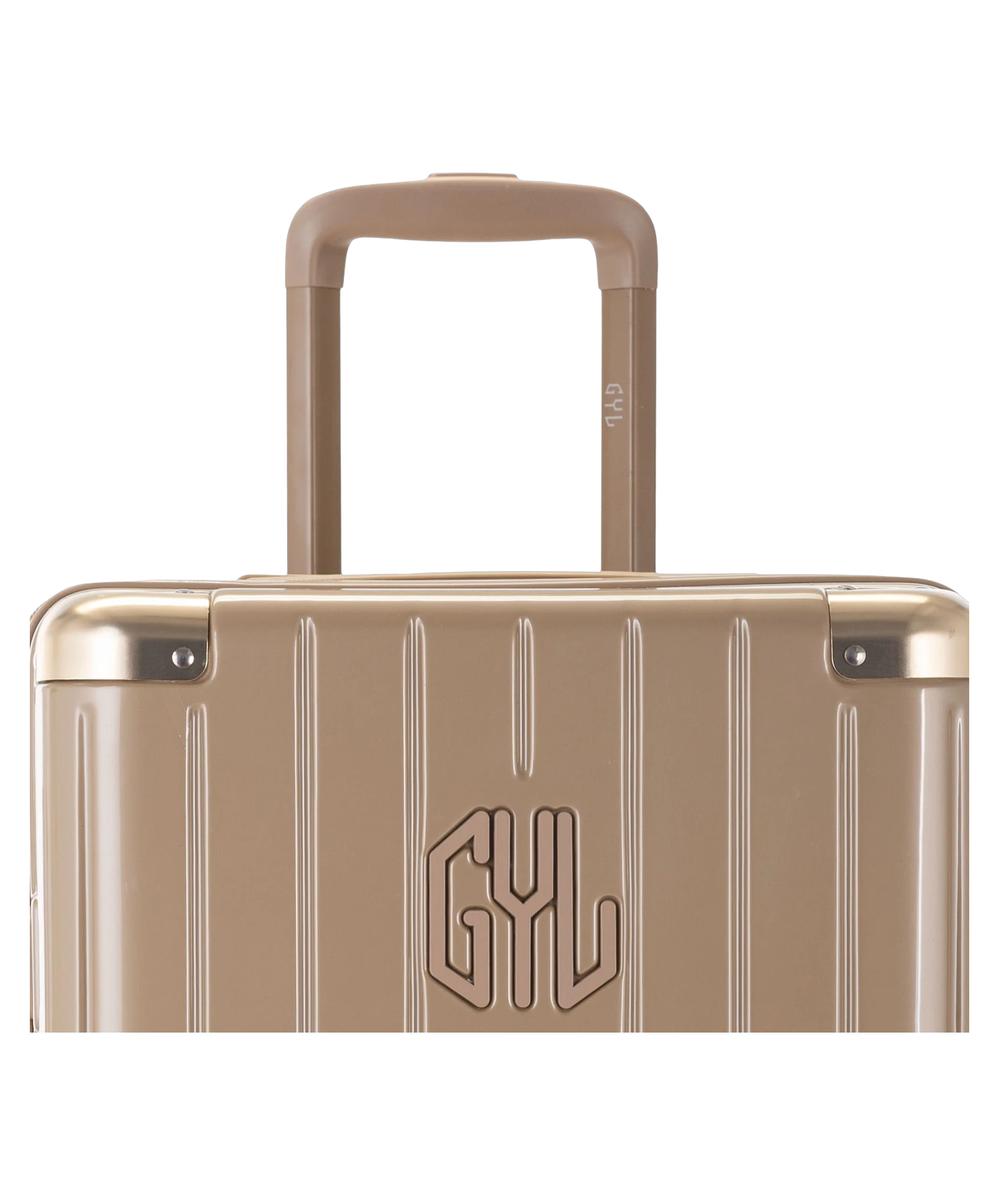 Valise Trunk XL Intemporelle GYL en polycarbonate 78 cm coloris champagne gros plan sur la poignee trolley et les coins renforces
