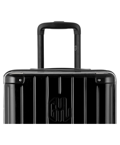 Valise Trunk XL Intemporelle GYL en polycarbonate 78 cm coloris noir gros plan sur la poignee trolley et les coins renforces